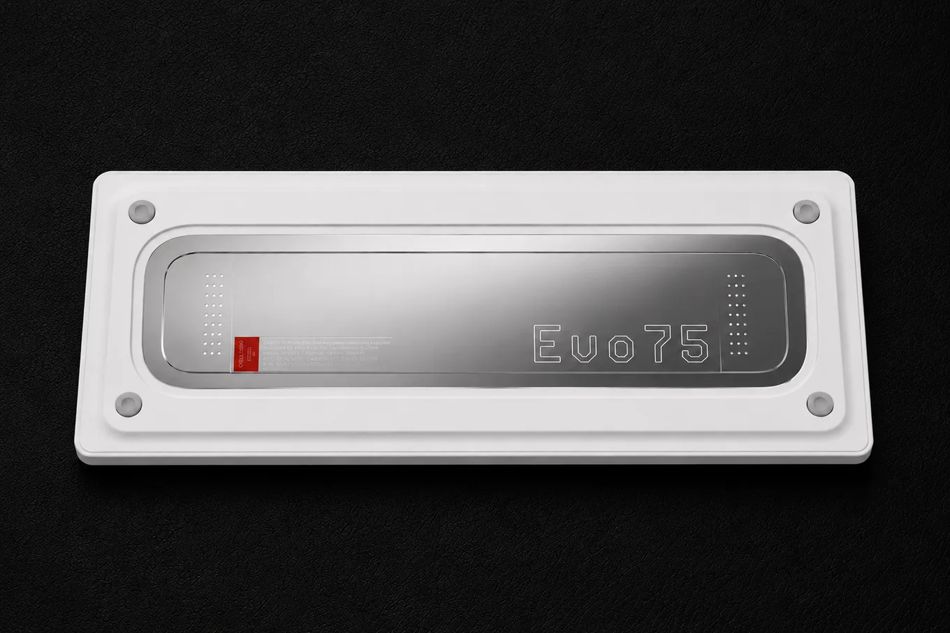Bottom view of the white EVO75 showing its polished silver rear weight, engraved logo and four feet.